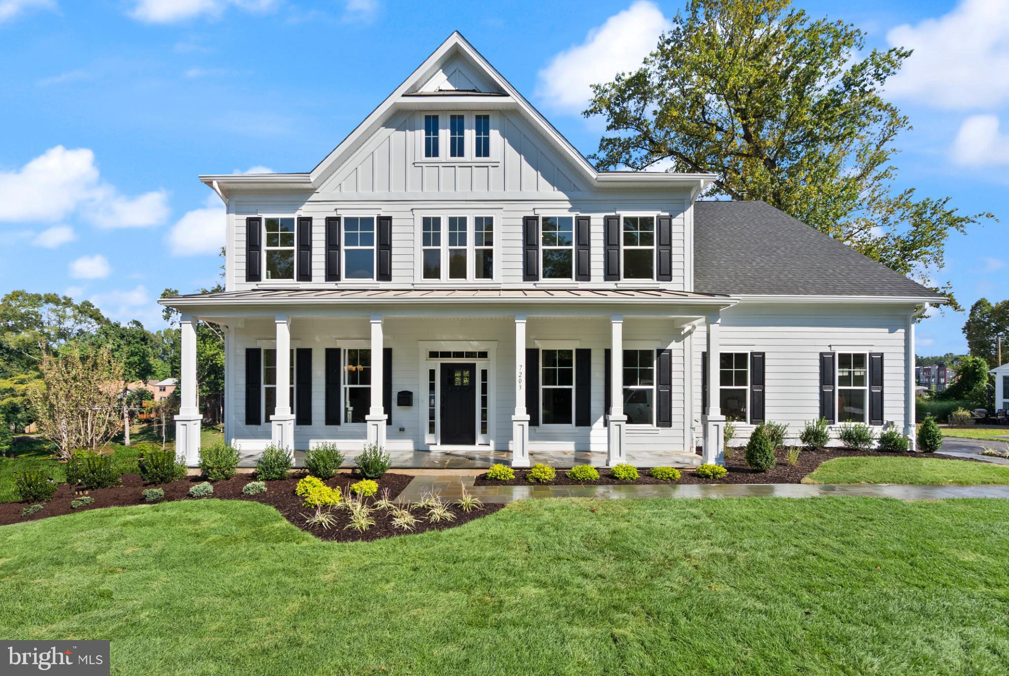 a front view of a house with yard and porch