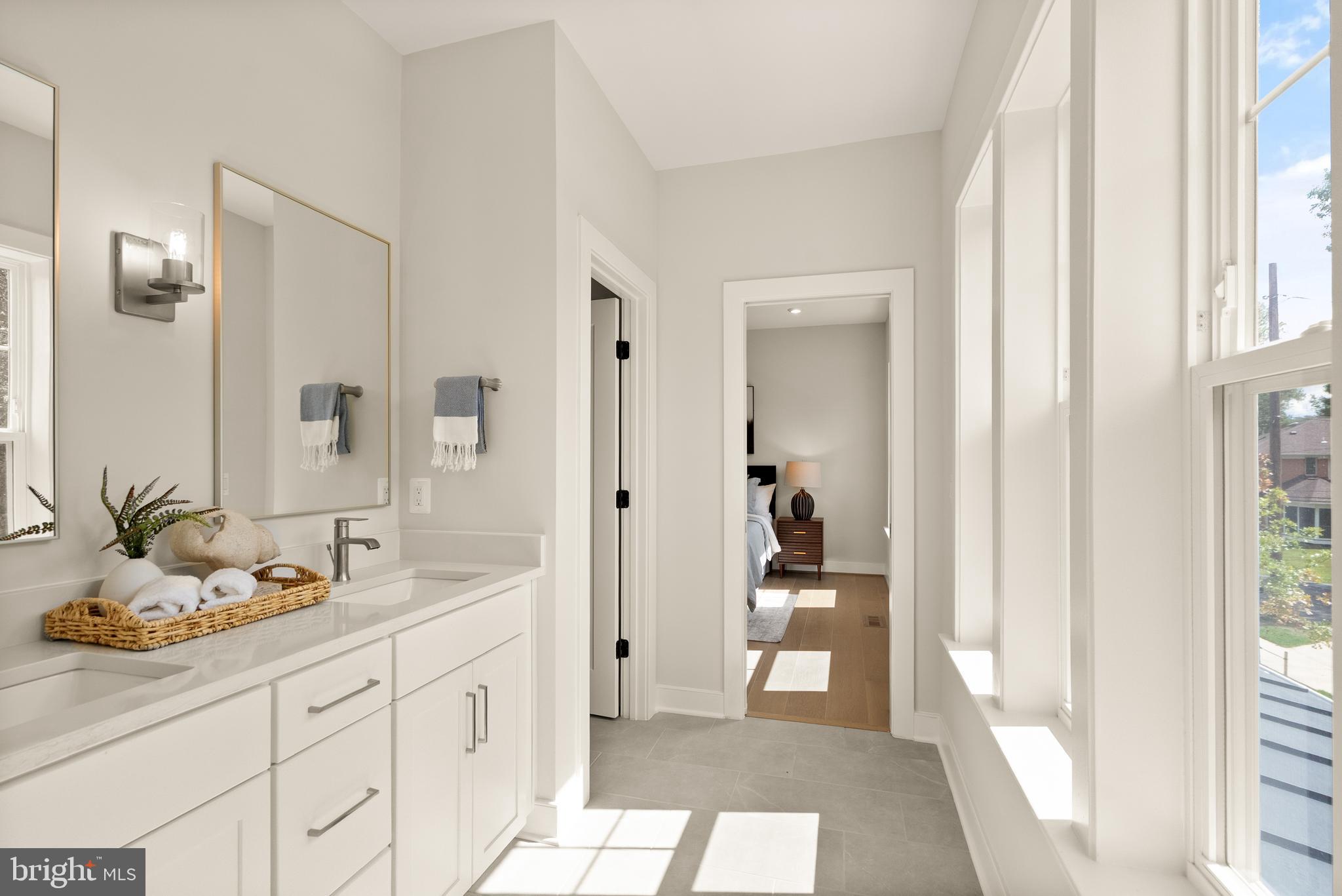 7203 Barnett Road Bethesda, MD 20817 - Photo 26 of 29 a spacious bathroom with a granite countertop sink and a mirror