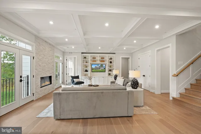a living room with fireplace furniture and a wooden floor