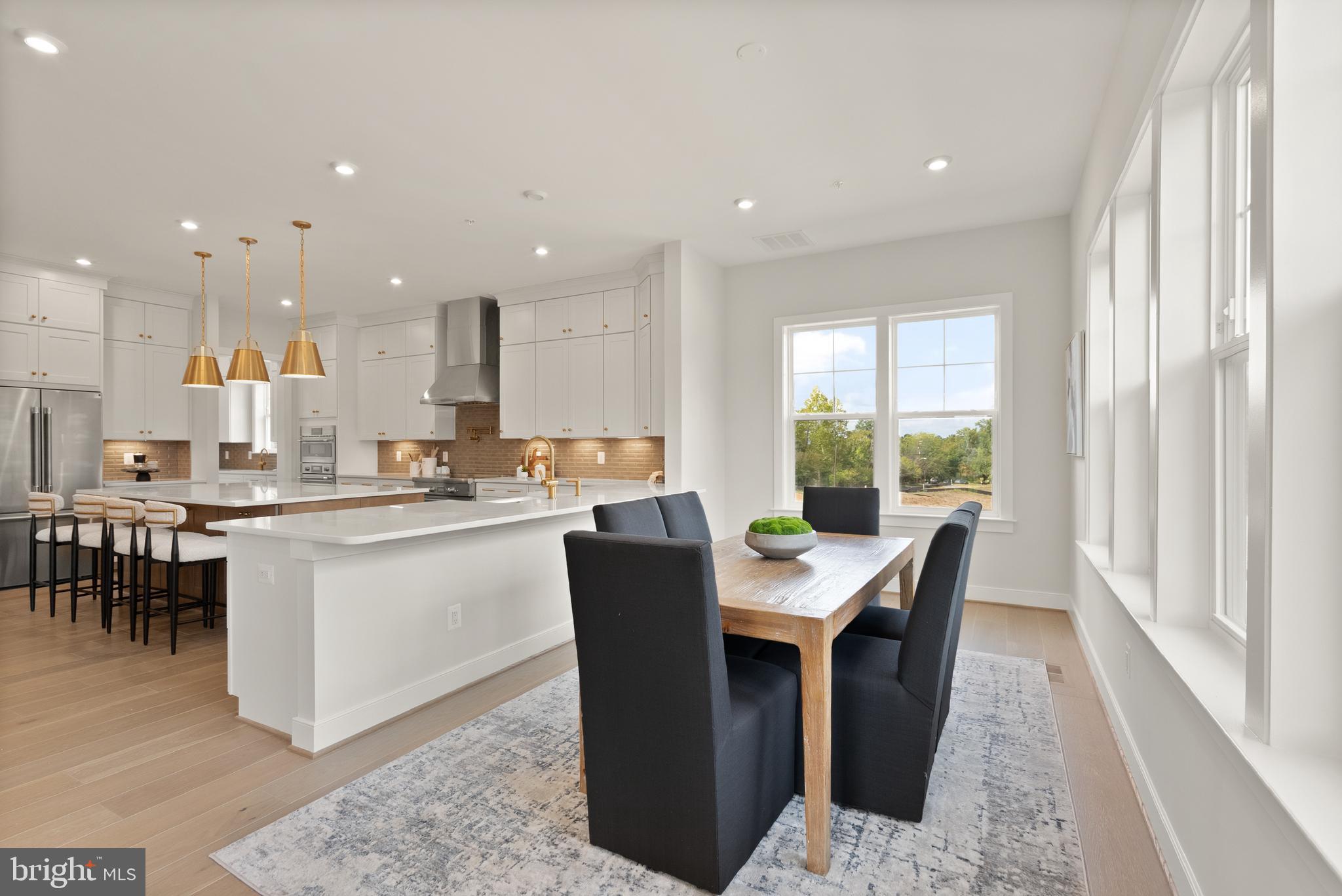 7203 Barnett Road Bethesda, MD 20817 - Photo 9 of 29 a kitchen with a dining table chairs and large windows