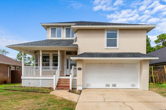 a front view of a house with a garage