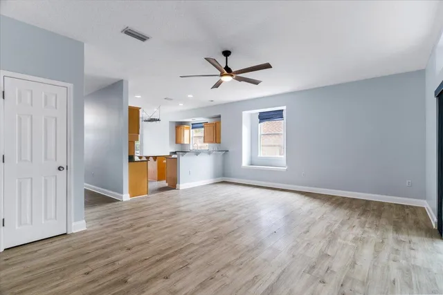 a view of a room with wooden floor