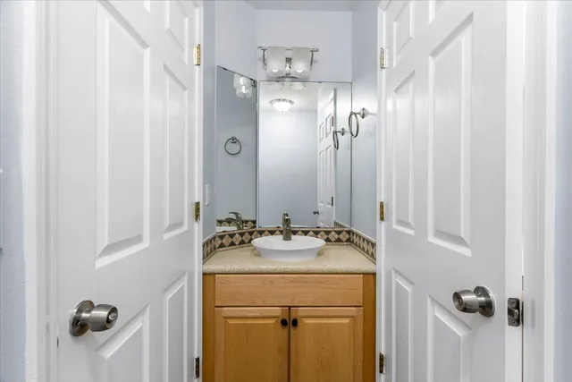 a bathroom with a sink toilet vanity and shower