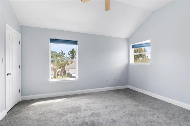 an empty room with windows and cabinet