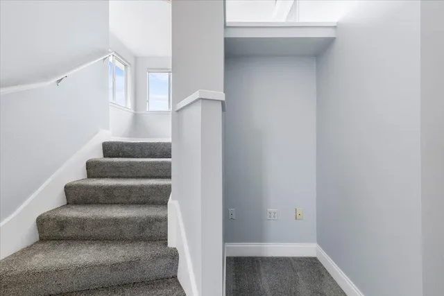 a view of an empty room with a ceiling fan