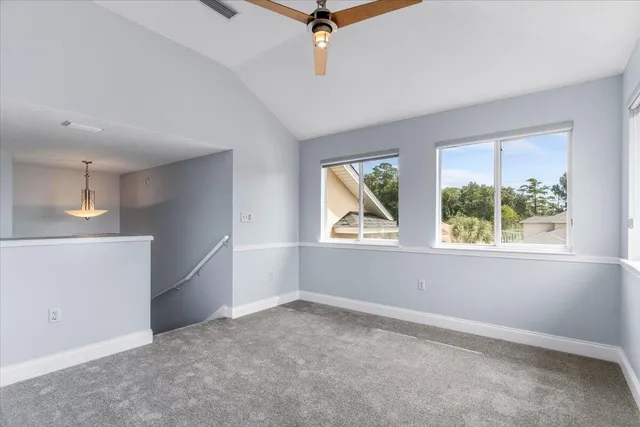 a view of walk in closet with empty racks