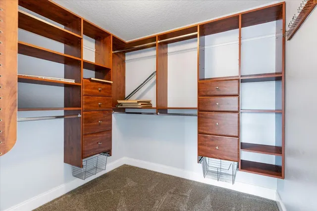a view of a livingroom with a ceiling fan and window
