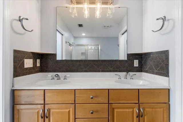 a view of a house with a yard and wooden fence