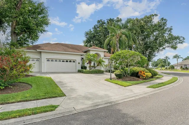a view of a house with a yard and garage