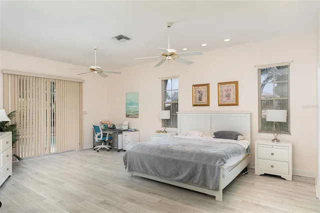 a bedroom with a bed a table and chair