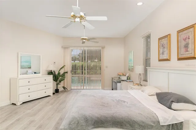 a bedroom with a bed and a chandelier fan