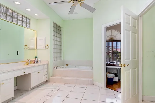 a spacious bathroom with a bathtub sink and mirror