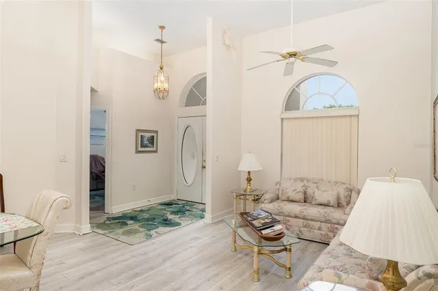 a living room with furniture a rug and white walls