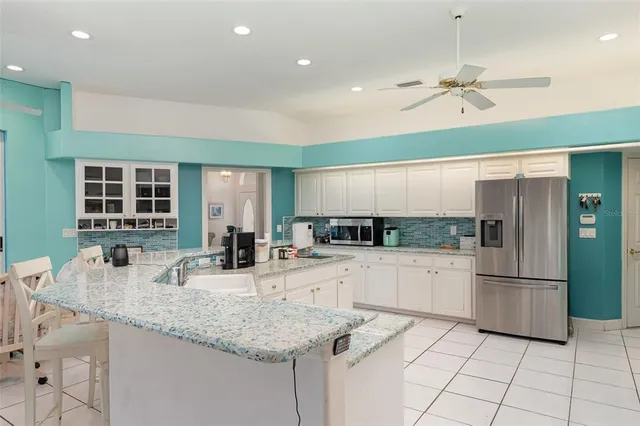 a kitchen with center island and stainless steel appliances