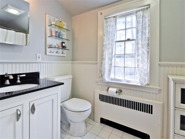 115 Clarke Road Needham, MA 02492 - Photo 13 of 21 a bathroom with a granite countertop sink a toilet and a window