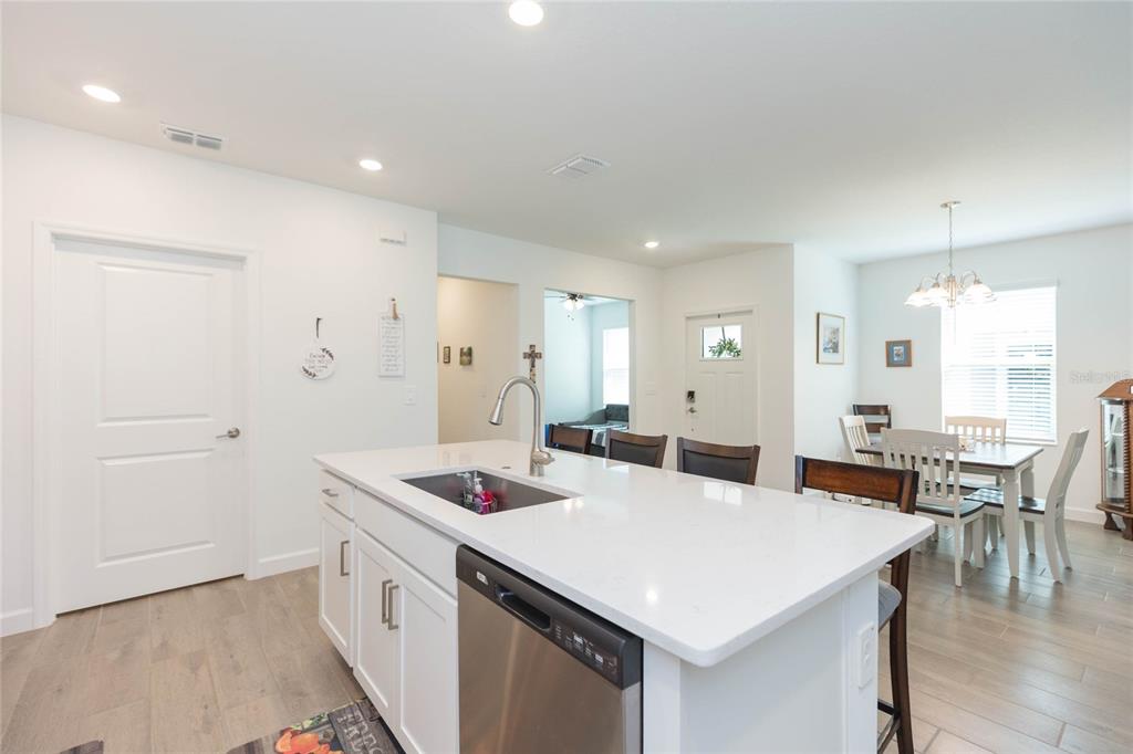 10806 Gable Dig Loop San Antonio, FL 33576 - Photo 20 of 73 a kitchen that has a lot of cabinets a sink and a stove in it