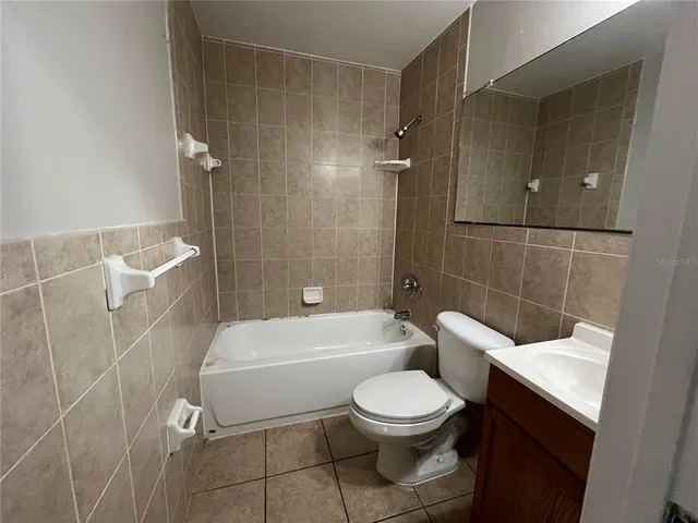 a bathroom with a toilet a sink and bathtub