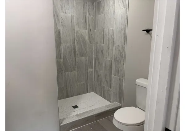 a bathroom with a toilet a sink and shower