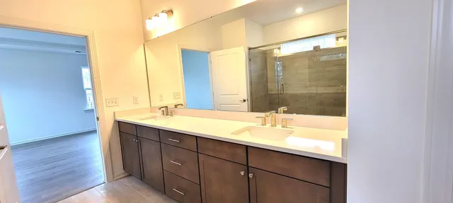 a bathroom with a double vanity sink and a mirror