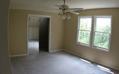 82 Highland Ridge Road Ellijay, GA 30540 - Photo 11 of 14 an empty room with windows and fan