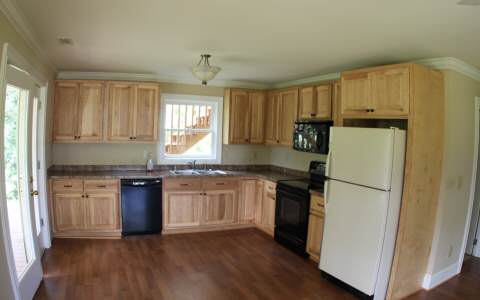 82 Highland Ridge Road Ellijay, GA 30540 - Photo 5 of 14 a kitchen with granite countertop a refrigerator stove top oven and sink