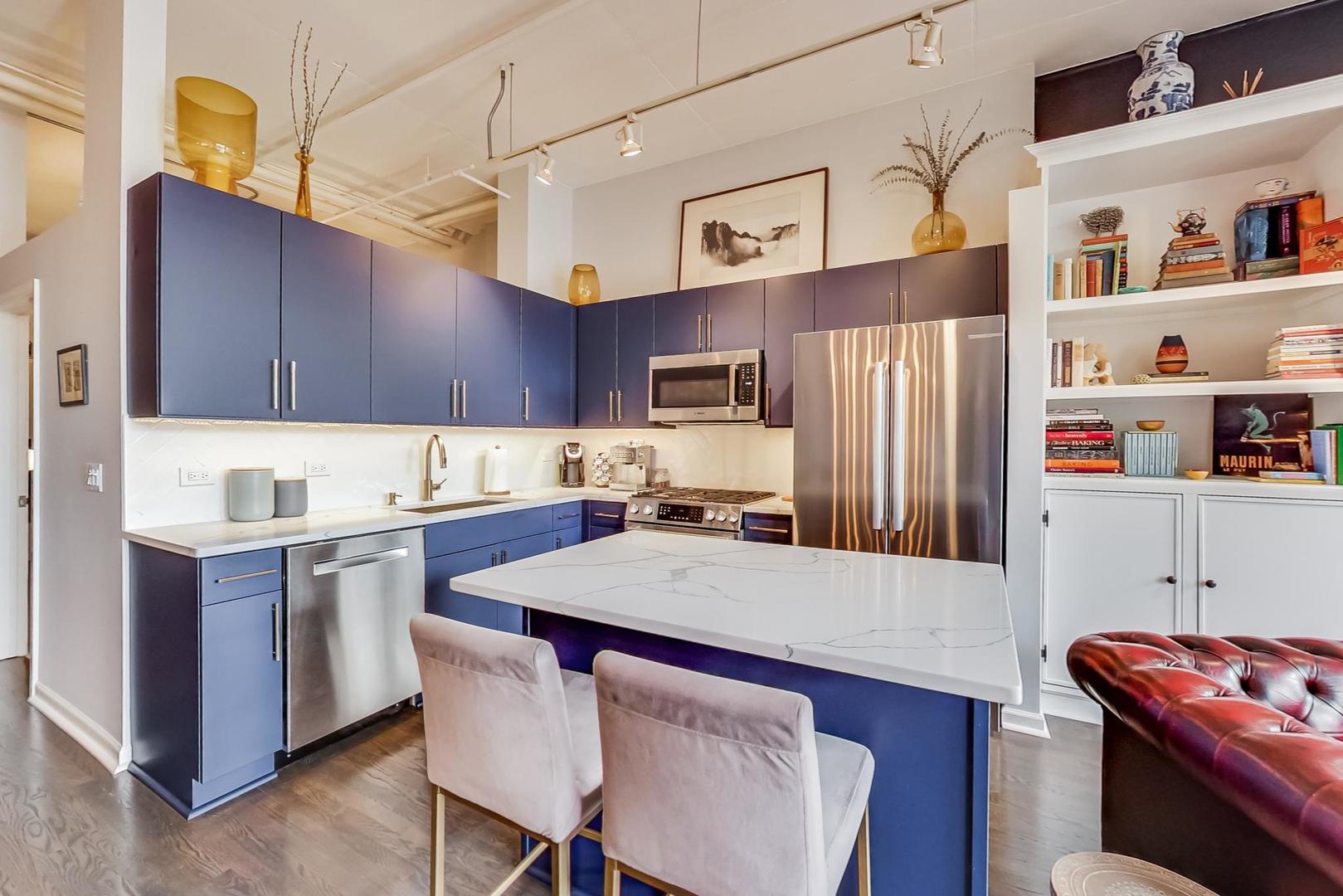 1301 West Madison Street, Unit 216 Chicago, IL 60607 - Photo 16 of 31 a kitchen with stainless steel appliances a sink a stove a refrigerator and cabinets