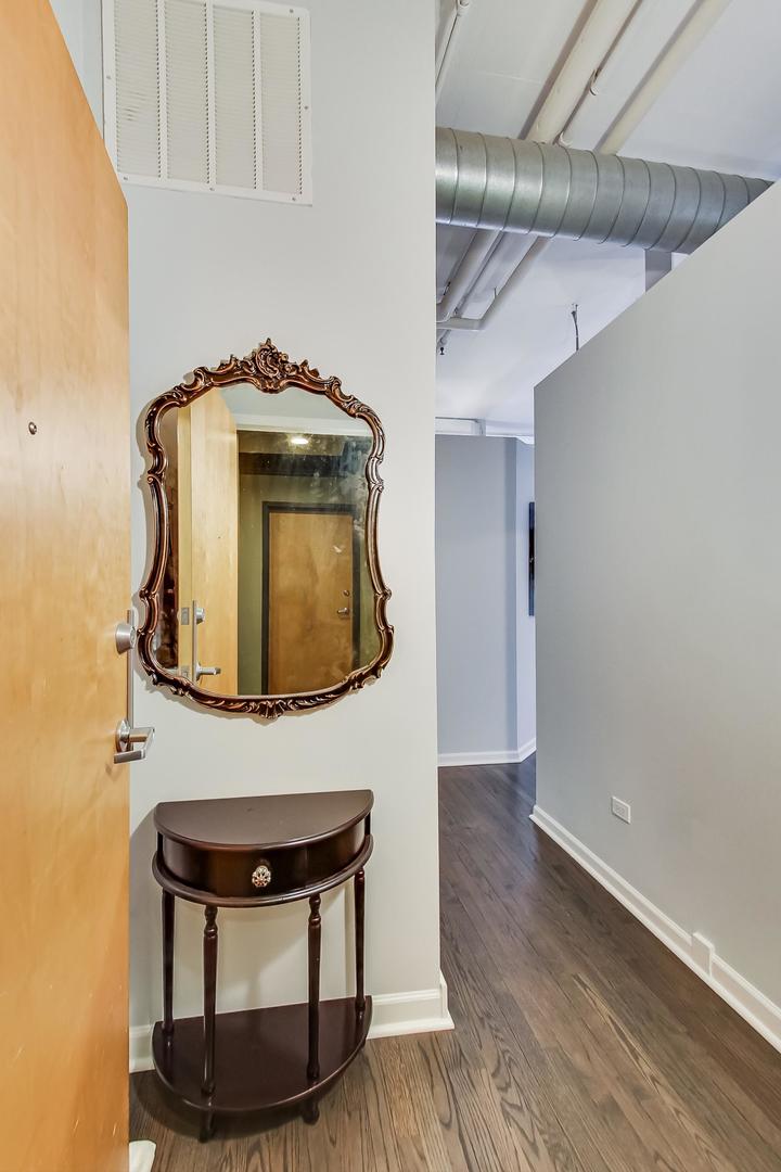 1301 West Madison Street, Unit 216 Chicago, IL 60607 - Photo 7 of 31 a view of livingroom with washer and dryer