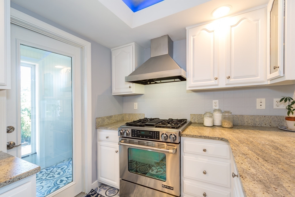 2 Beverly Road Natick, MA 01760 - Photo 11 of 40 a kitchen with stainless steel appliances granite countertop a stove a sink and a white cabinets