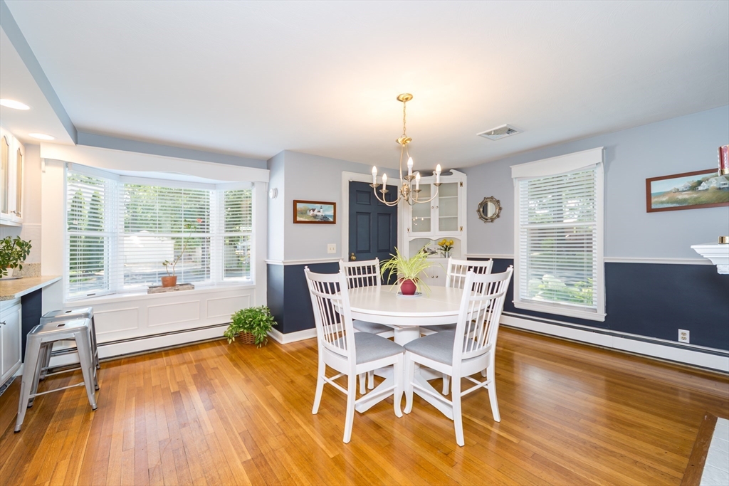 2 Beverly Road Natick, MA 01760 - Photo 16 of 40 a view of a dining room with furniture a chandelier and wooden floor