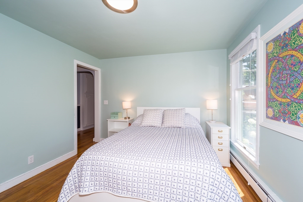 2 Beverly Road Natick, MA 01760 - Photo 27 of 40 a bedroom with a bed and painting on the wall
