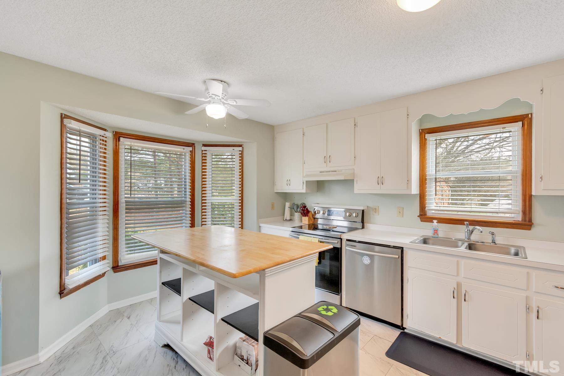 5244 Carrier Way Raleigh, NC 27603 - Photo 14 of 25 a kitchen with sink cabinets and wooden floor