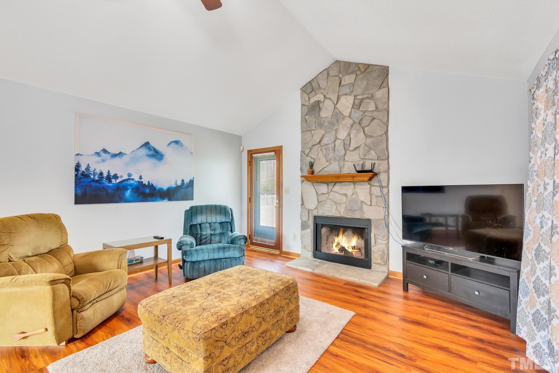5244 Carrier Way Raleigh, NC 27603 - Photo 8 of 25 a living room with furniture and a fireplace