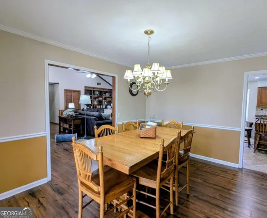 a view of a dining room with furniture wooden floor and chandelier