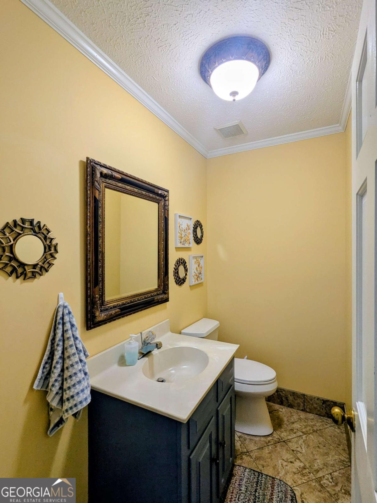 2005 Adams Street Vidalia, GA 30474 - Photo 20 of 50 a bathroom with a toilet sink and mirror