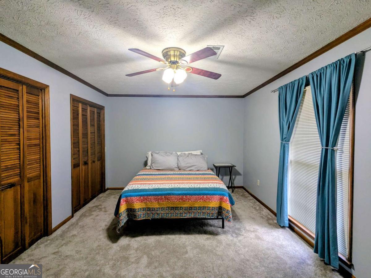 2005 Adams Street Vidalia, GA 30474 - Photo 24 of 50 a room with a bed and a chandelier