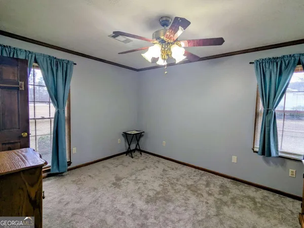 a spacious bedroom with a bed and a window