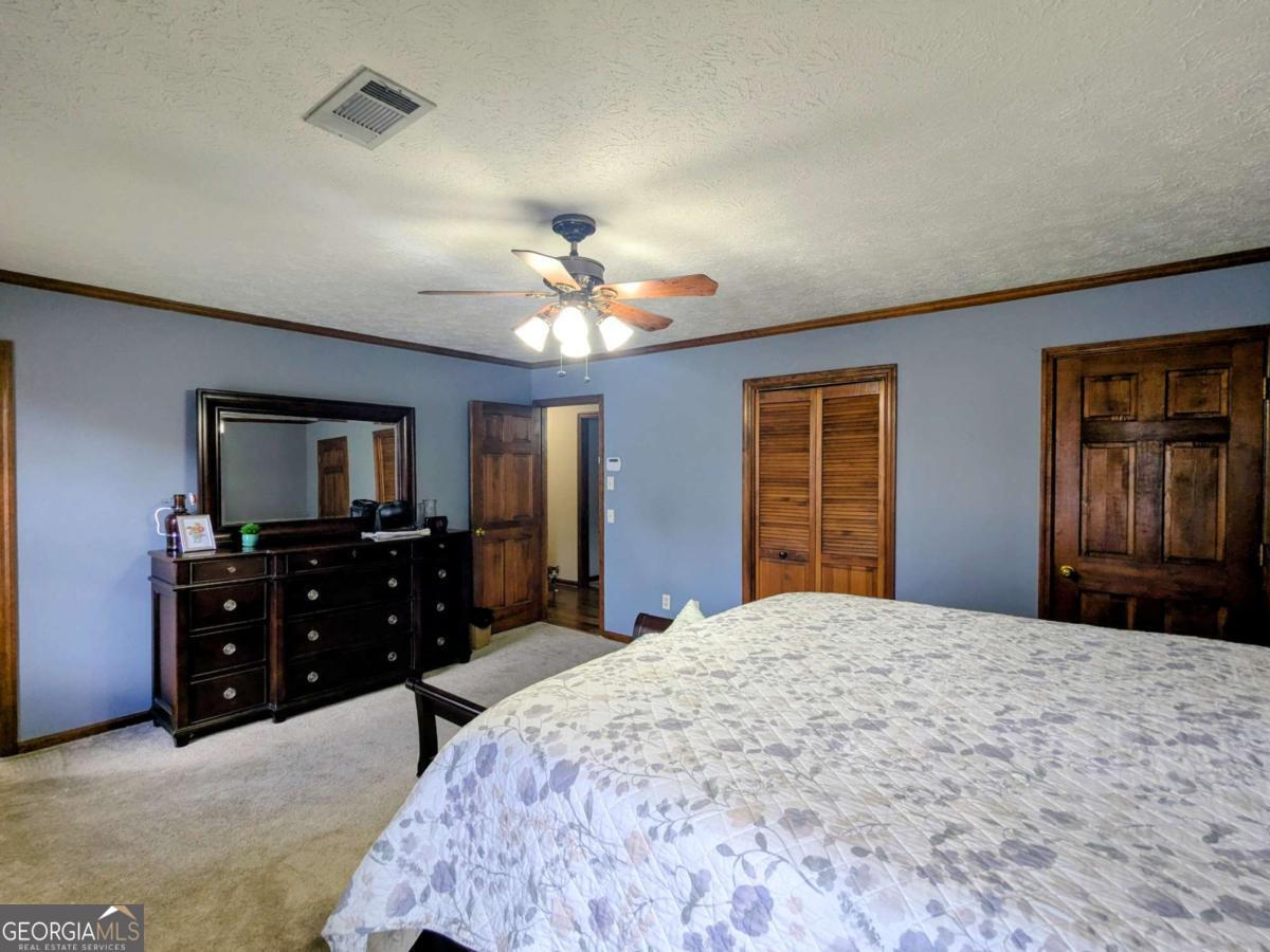2005 Adams Street Vidalia, GA 30474 - Photo 32 of 50 a bedroom with a bed and a dresser