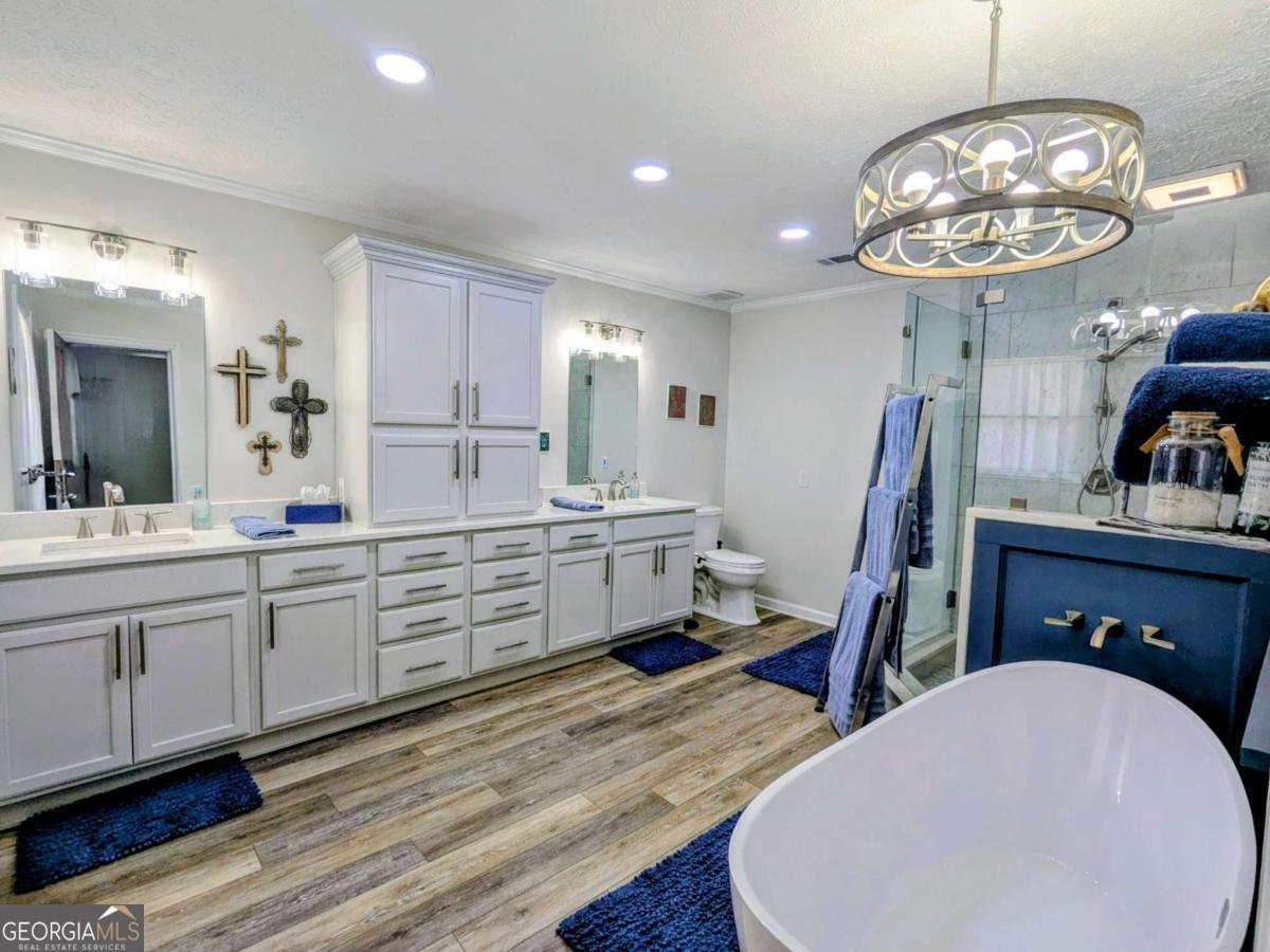 2005 Adams Street Vidalia, GA 30474 - Photo 35 of 50 a spacious bathroom with a granite countertop sink a toilet and a mirror
