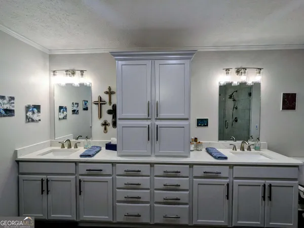 a spacious bathroom with a sink a large mirror a bathtub and a shower