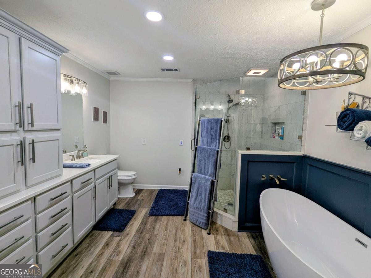 2005 Adams Street Vidalia, GA 30474 - Photo 37 of 50 a spacious bathroom with a sink a large mirror a bathtub and a shower