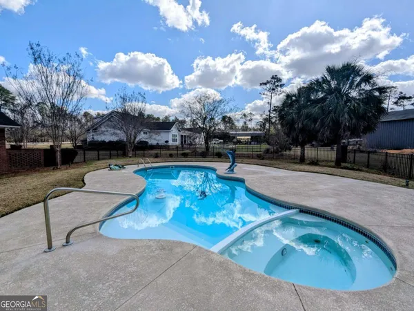 a view of a swimming pool and a yard