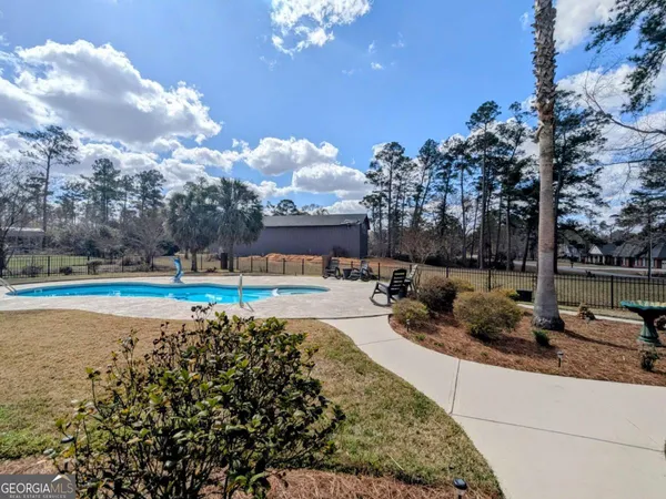 a view of a swimming pool with a patio
