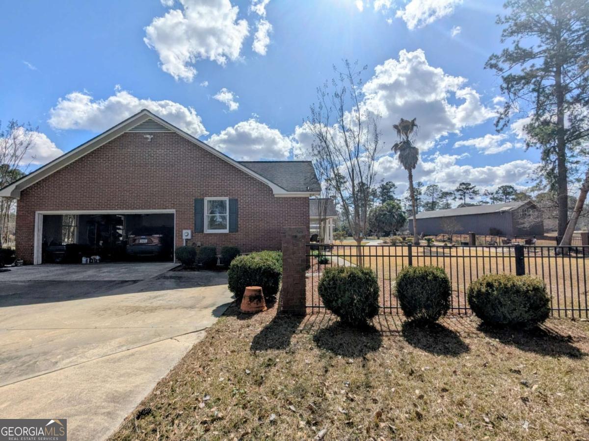 2005 Adams Street Vidalia, GA 30474 - Photo 48 of 50 a view of a house with a large tree in the yard