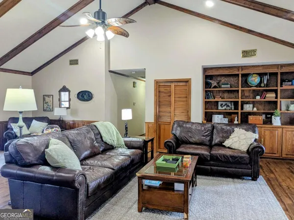 a living room with furniture and a bookshelf