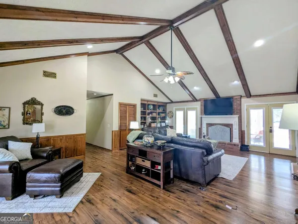 a living room with furniture and wooden floor