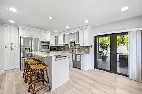 6140 Southwest 56th Court Davie, FL 33314 - Photo 15 of 69 White kitchen perfection with a tropical twist!