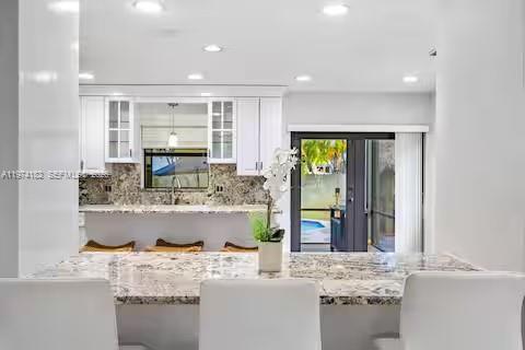 6140 Southwest 56th Court Davie, FL 33314 - Photo 18 of 69 All-white kitchen paradise with granite waterfall island!