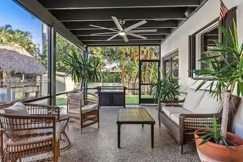 6140 Southwest 56th Court Davie, FL 33314 - Photo 50 of 69 Tropical lanai with rattan furniture and lush plants!