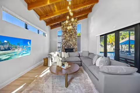 6140 Southwest 56th Court Davie, FL 33314 - Photo 5 of 69 This living room’s so cozy and chic, even the stone fireplace is flexing its glow-up!