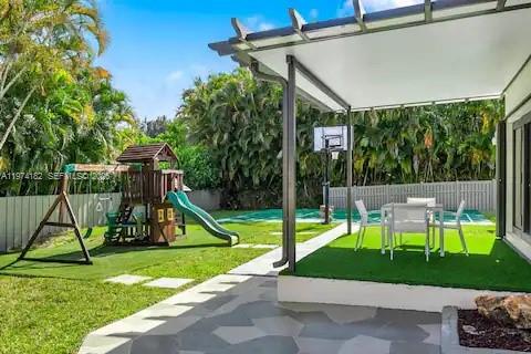 6140 Southwest 56th Court Davie, FL 33314 - Photo 57 of 69 Family backyard paradise with playground and pergola dining!